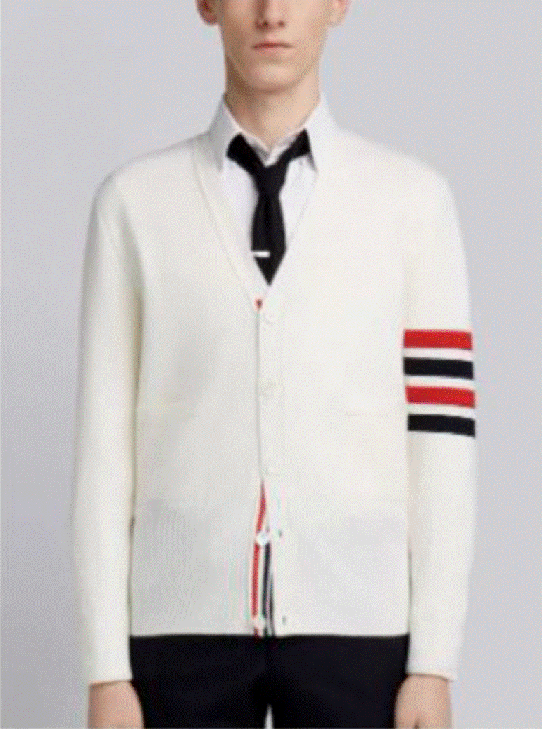 A person wearing a white sweater with red and blue stripes

Description automatically generated