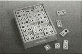 A box of dominoes with small pieces

Description automatically generated with medium confidence