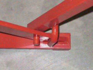 A red metal bar on a concrete floor

Description automatically generated