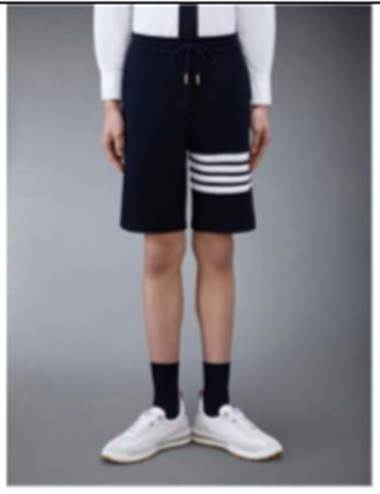 A person wearing shorts and white shoes

Description automatically generated